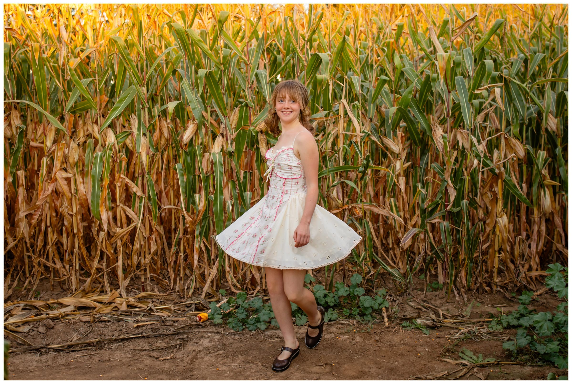 teen twirling in cornfields during photography session at Anderson Farms in Erie Colorado 