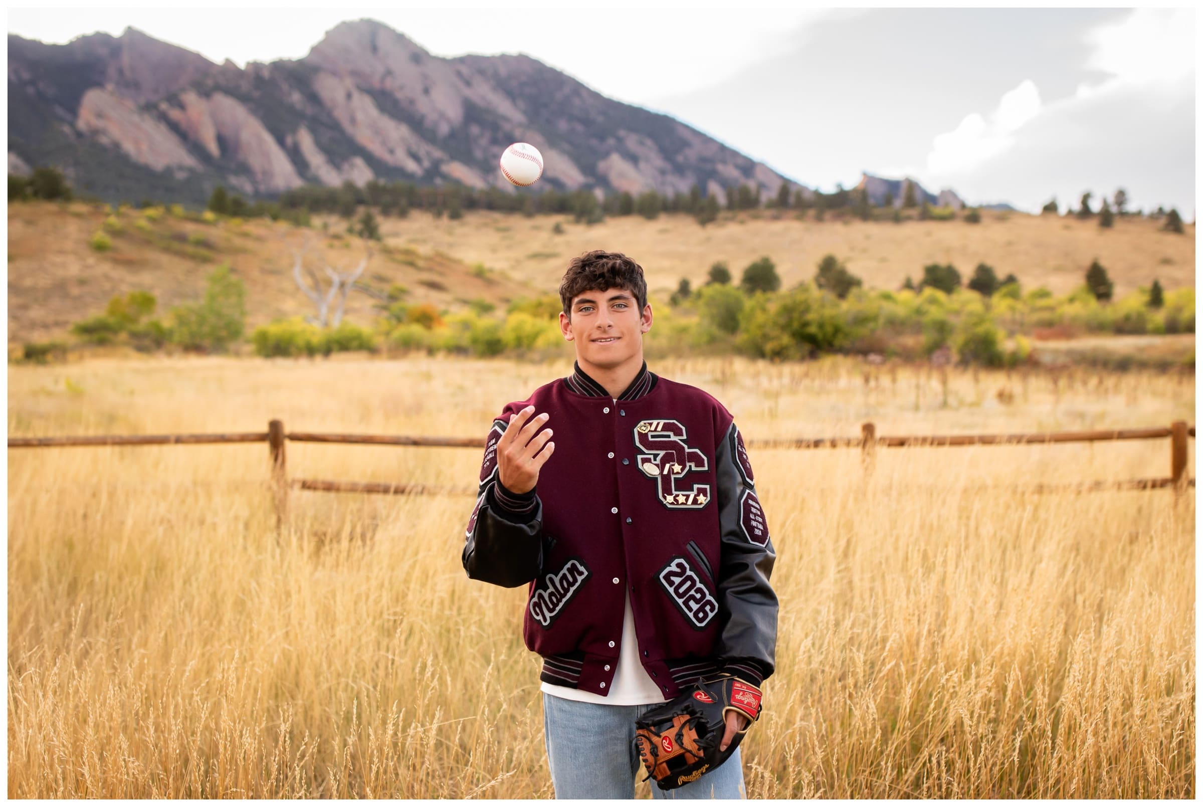 Silver Creek High School senior tossing baseball into the air during Colorado senior portraits at South Mesa trail