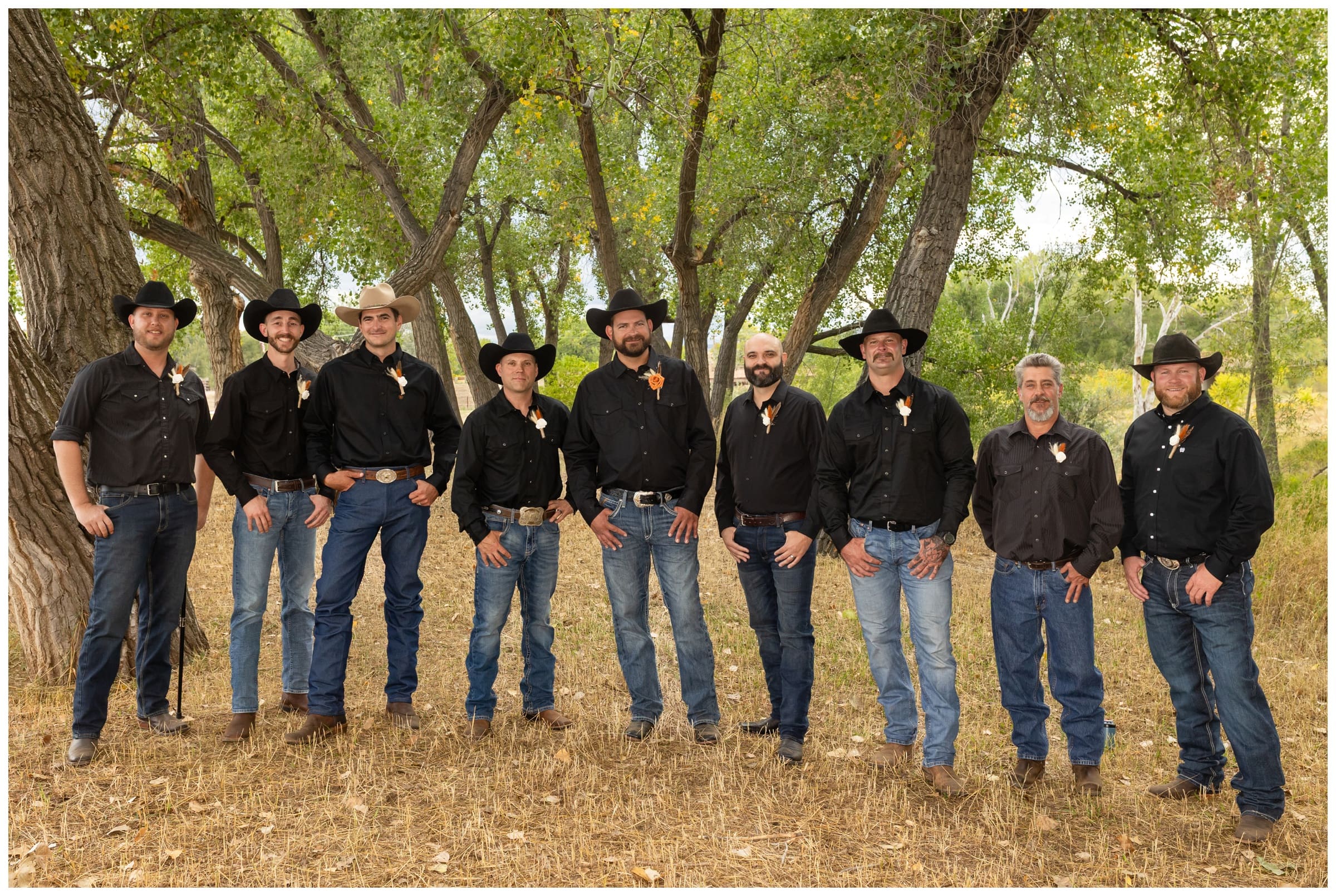 groomsmen in jeans and cowboy hats during rustic Colorado farm wedding