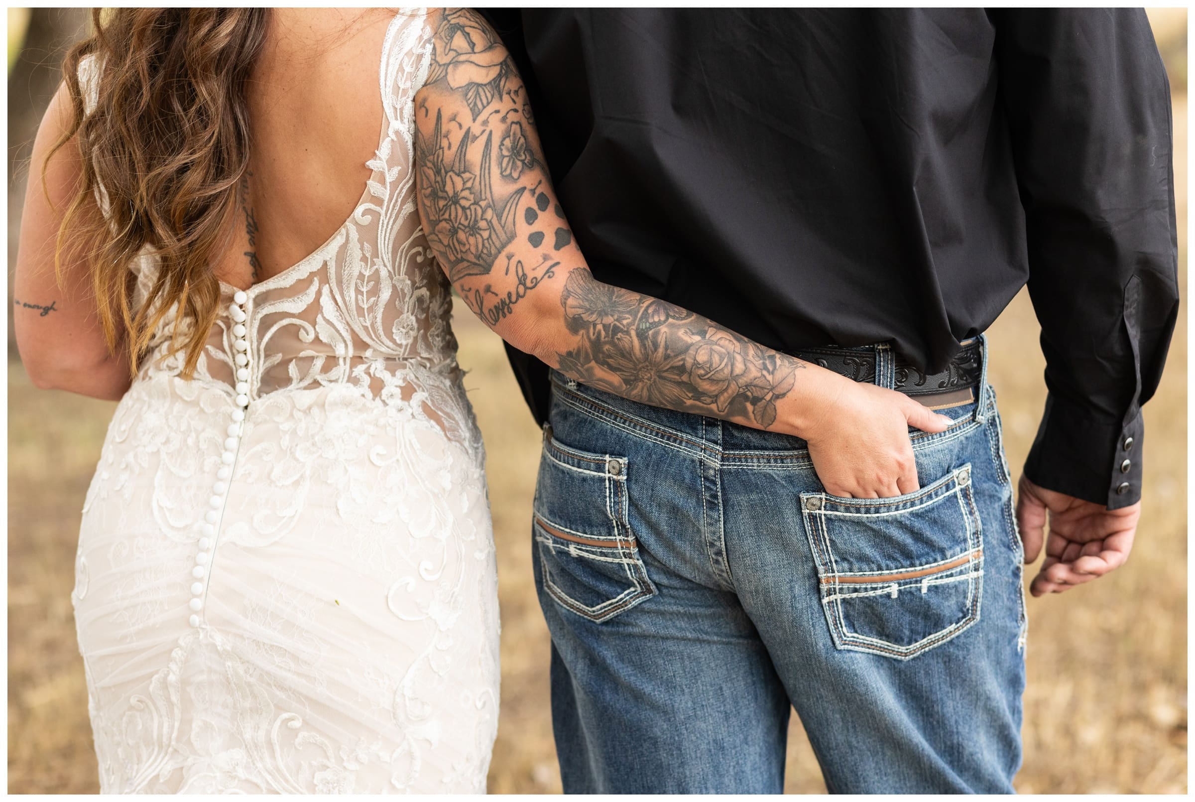 bride with hand in groom's pocket during rustic fall Longmont Colorado wedding photography by Plum Pretty Photography