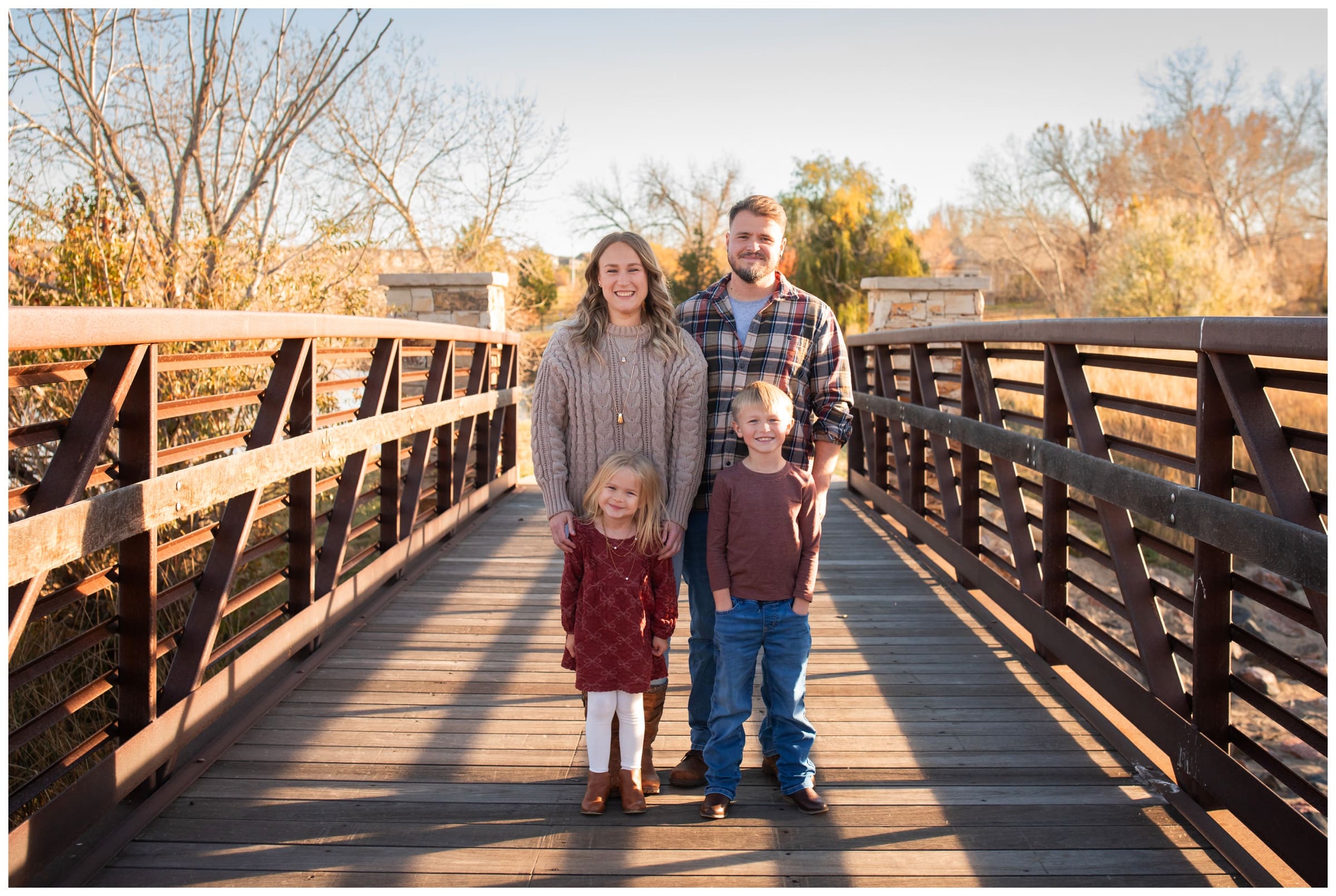 family posing on bridge behind Buffalo Ridge Medical Center in Erie, Colorado