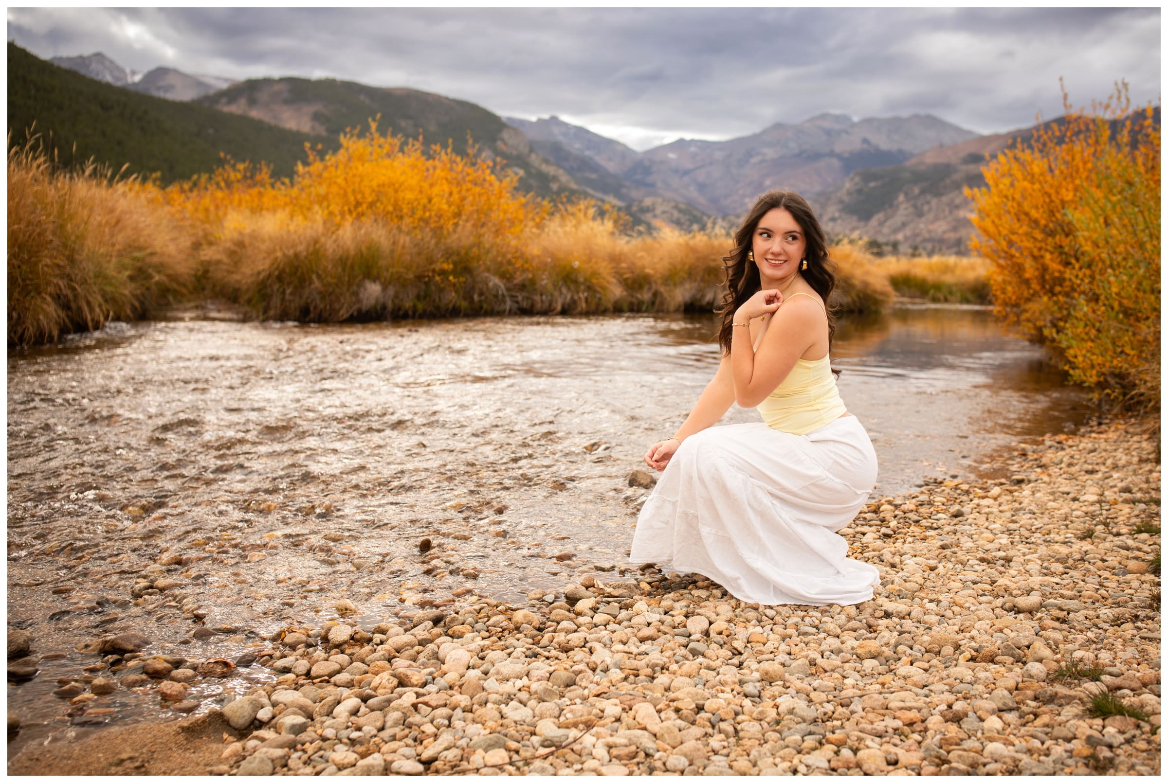 teen posing next to river in RMNP during Colorado mountain senior pictures by Plum Pretty Photography 