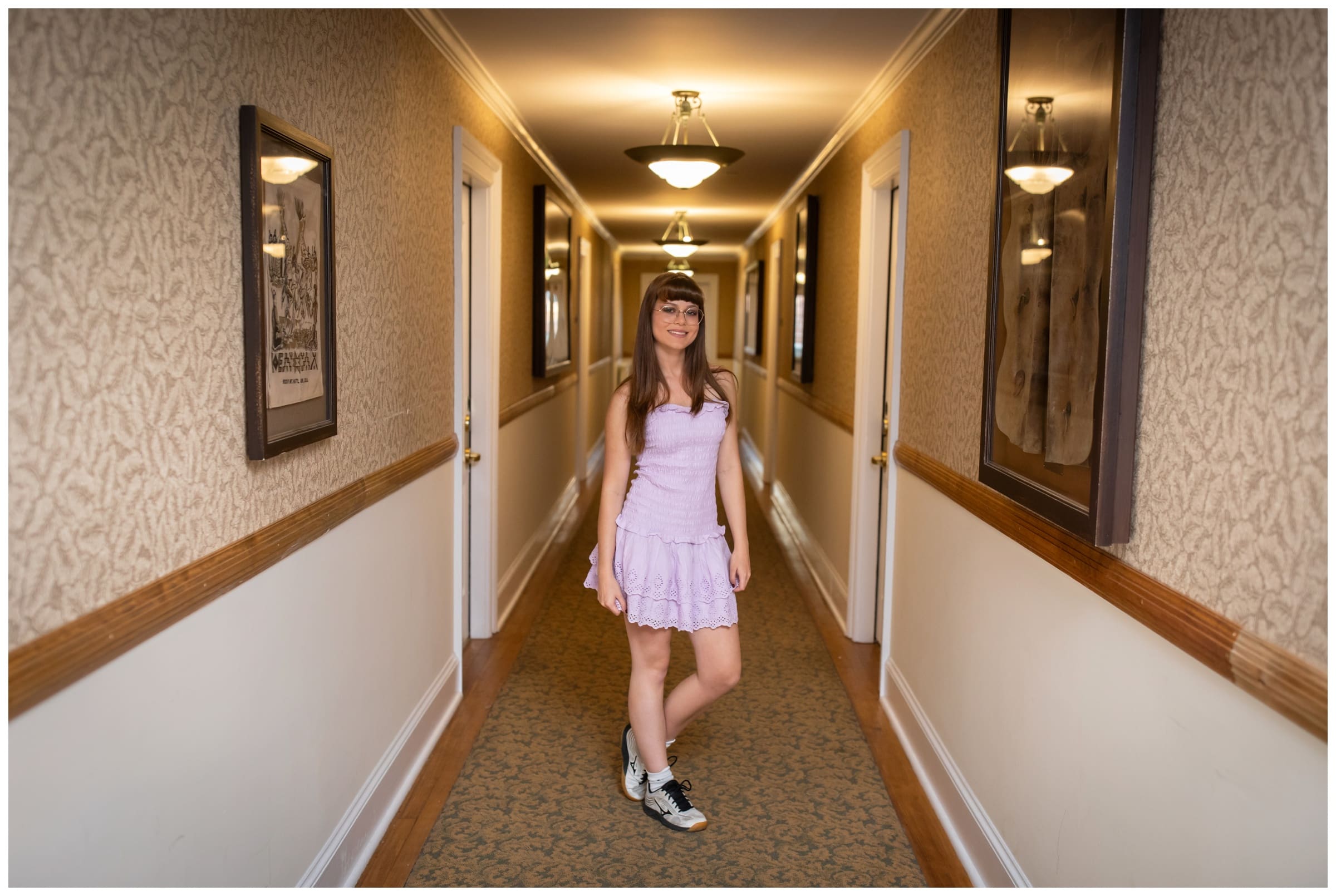teen posing in the hallways of the Stanley Hotel during unique senior pictures in Estes Park 