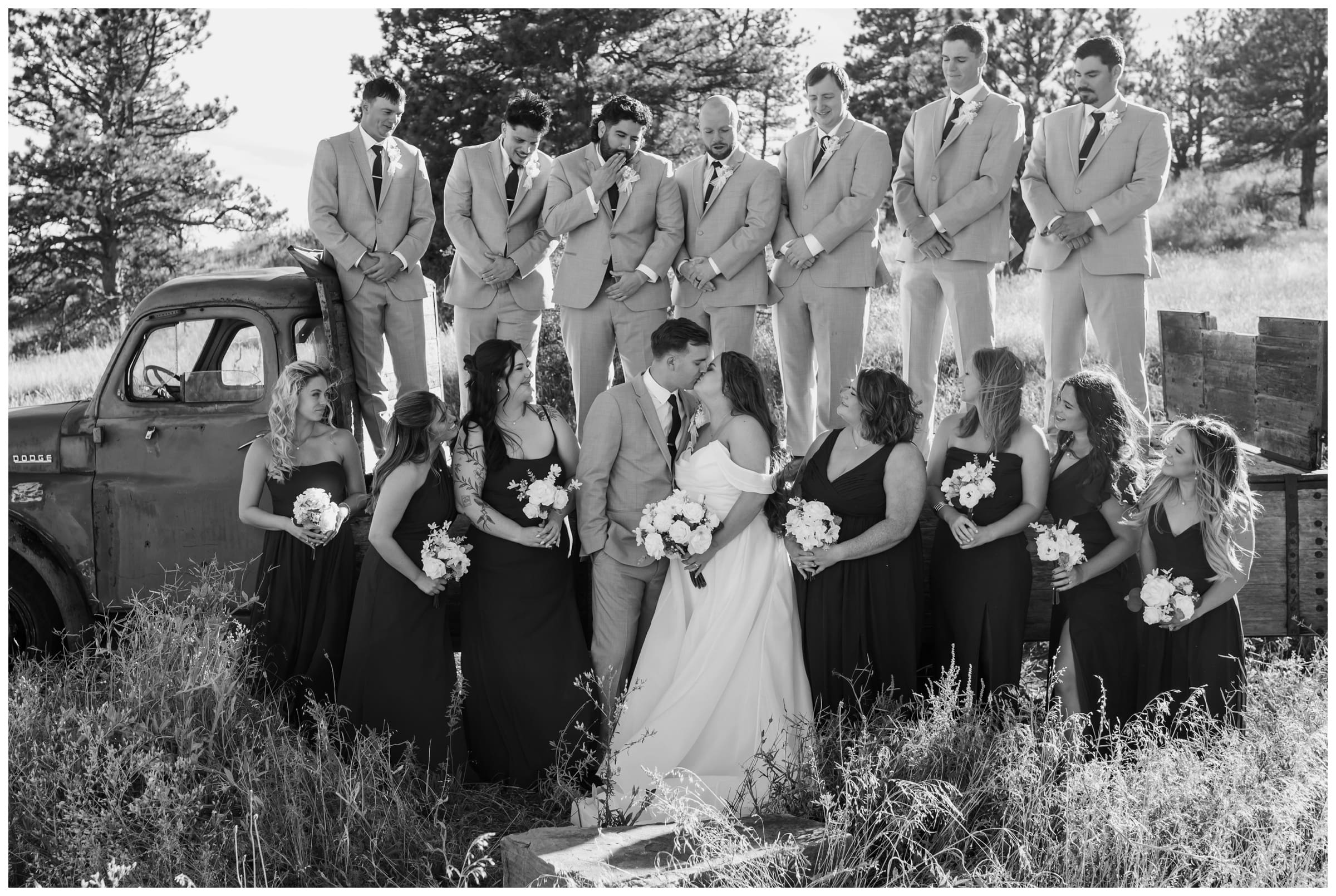 wedding party posing on vintage truck at Lionscrest Manor in Colorado 