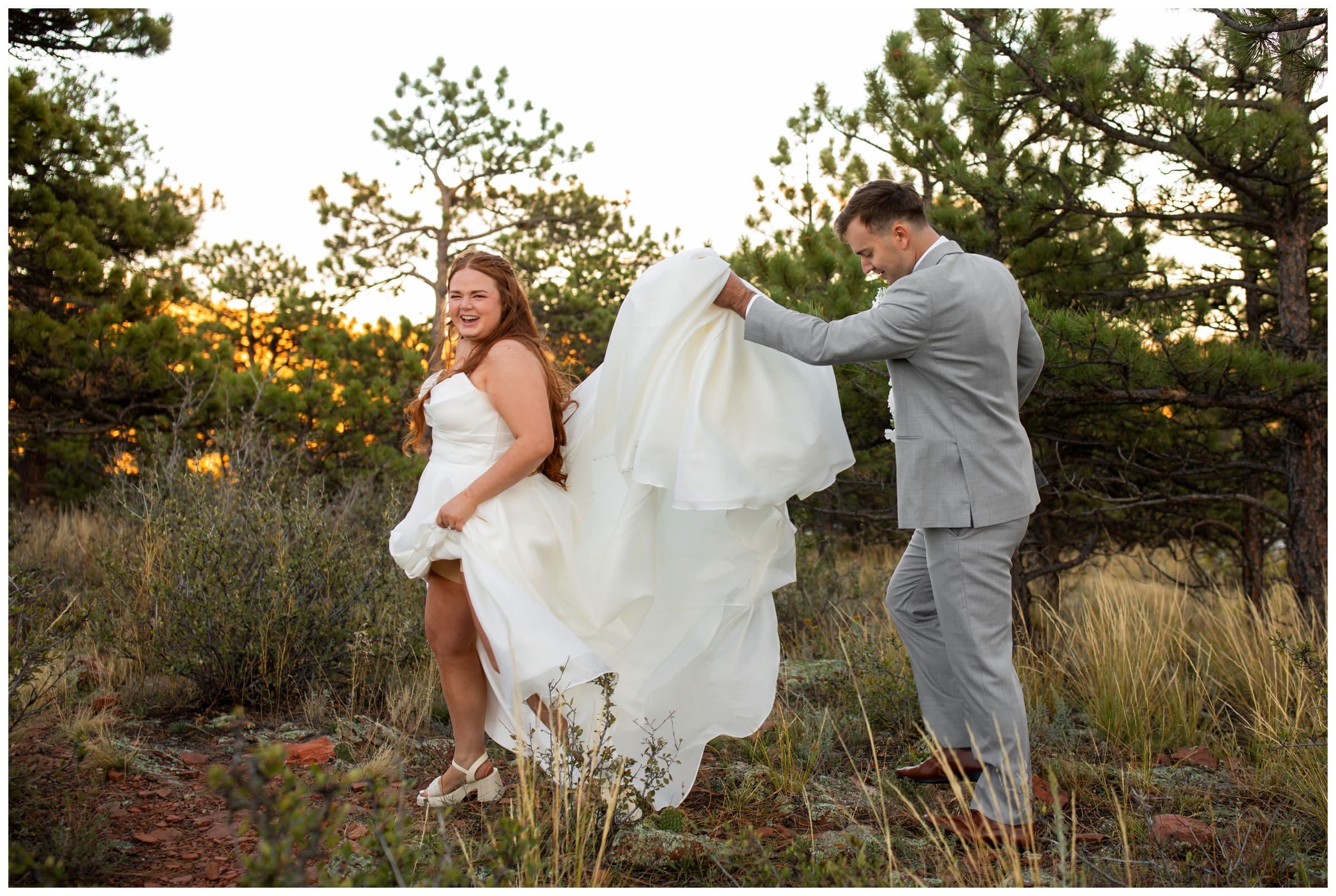 groom carrying bride's dress during Colorado fall wedding photos at Lionscrest Manor Wedgewood 
