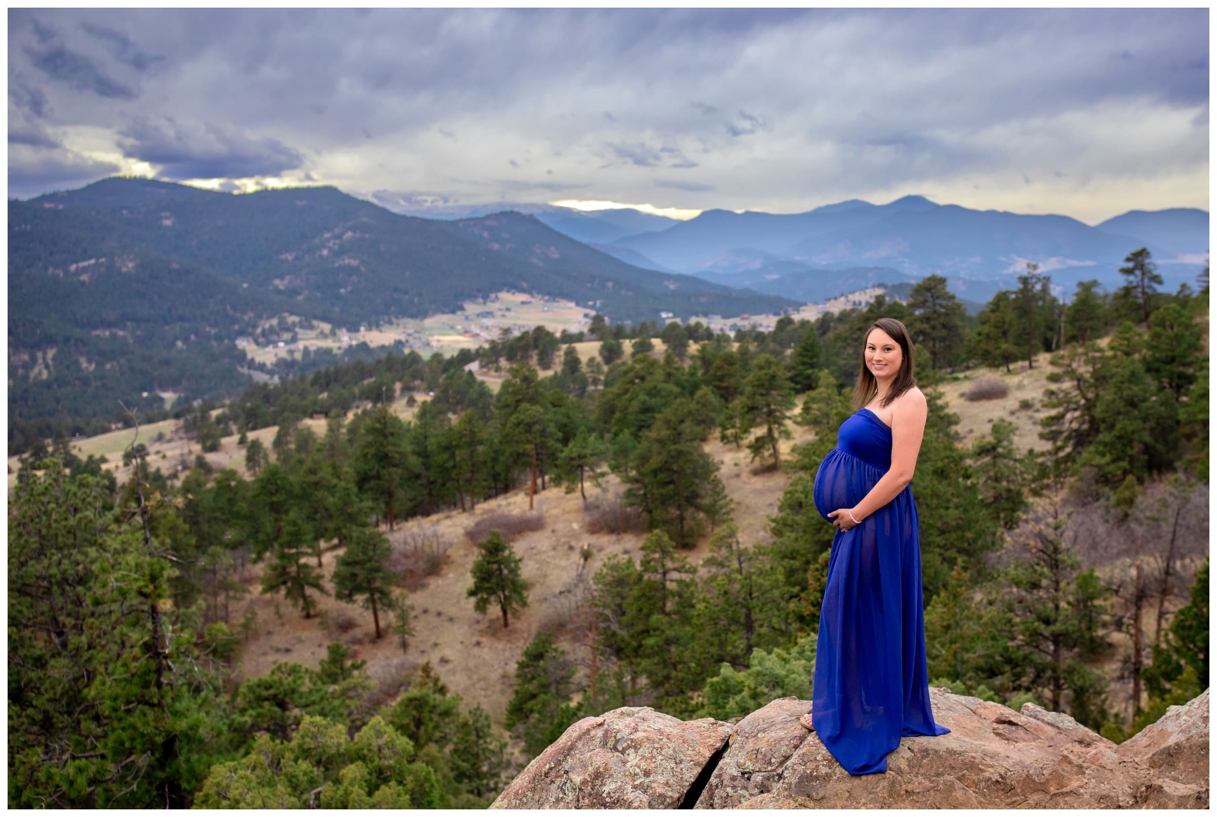 pregnant woman posing in the mountains for spring maternity photos at Mount Falcon West in Colorado